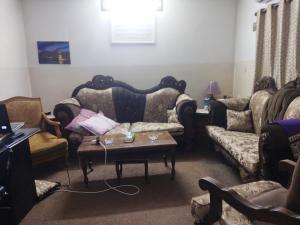 a living room with couches and a coffee table at Welcome back in Al Hāshimīyah