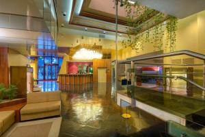 a lobby with a couch and a chandelier at Hotel Federico II in Iesi