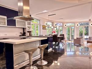 a kitchen with a counter and a dining room at Royal Sun Villa in Sarajevo