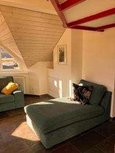 a bedroom with a green bed and a couch at Serravalle - Casermetta in Malvaglia +23 photos