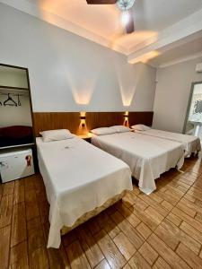 a hotel room with two beds in a room at New Comercial Palace Hotel in São Paulo +41 photos