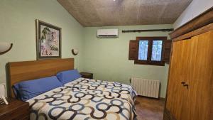 a bedroom with a bed and a window and a door at Can Micos - Masía de grupos 16 hasta 25 personas in Riudarenes +29 photos