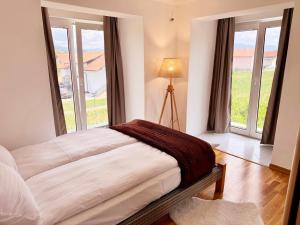 a bedroom with a bed and large windows at Royal Sun Villa in Sarajevo +43 photos
