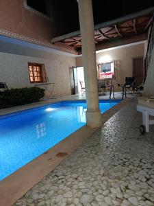 a large swimming pool in a building with at villa ourika complette in Sbiti