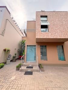 a house with a blue door and stairs in front at Barranco Boutique Hotel by 3B in Lima