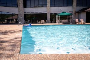 a large swimming pool in front of a building at Couples Condo Retreat Overlooking Golf Course in Branson West