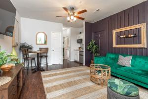 a living room with a green couch and a table at Couples Condo Retreat Overlooking Golf Course in Branson West +41 photos