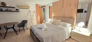 a bedroom with a bed and a table and a chair at Suite 58 rooms in Giulianova