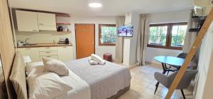 a bedroom with a bed and a table and a kitchen at Suite 58 rooms in Giulianova