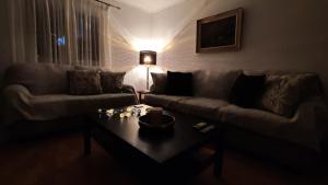 a living room with a couch and a coffee table at Avaton Myrina Apartment in Myrina +10 photos