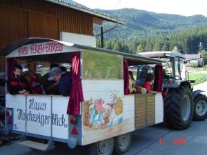 a group of people riding in a ride in a tractor at Haus Deutschmann in Wenns
