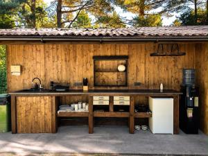a kitchen with a counter and a refrigerator at Baltic Beach Charm Tiny House C in Pērkone