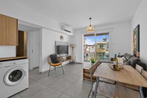 a kitchen and living room with a washing machine at WAKE UP BY THE SEA BEACHFRONT FLATS - Protaras in Protaras