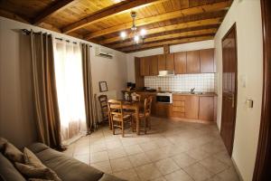 a kitchen and dining room with a table and chairs at The Stone Alley in Konitsa