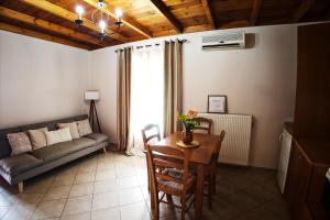 a living room with a table and a couch at The Stone Alley in Konitsa