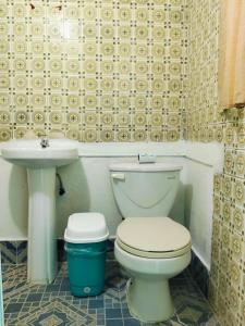 a bathroom with a toilet and a sink at Hotel Antequera in Oaxaca City