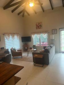 a large living room with couches and a tv at B's Hidden Paradise in Philipsburg