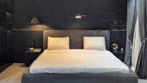 a bedroom with a large bed with two pillows at 4 Bedroom duplex in Orchid in Lekki
