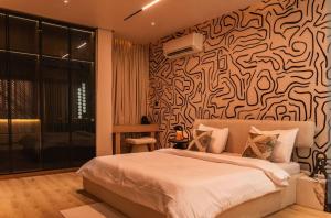 a bedroom with a large bed with a maze wall at 4 Bedroom duplex in Orchid in Lekki
