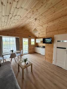 a living room with a couch and a table at Baltic Holidays in Gąski