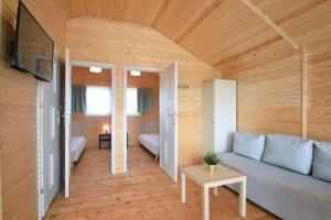 a living room with a couch and a table at Baltic Holidays in Gąski