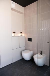 a bathroom with a toilet and a sink at Amber Sun Towers 11th Floor in Świnoujście +31 photos