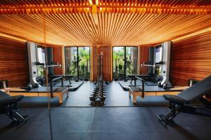 a gym with a row of treadmills and machines at Petit Ermitage in Los Angeles