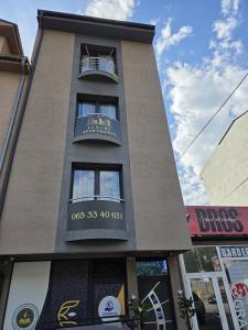 a tall building with a sign on it at NP Luxury Apartments in Novi Pazar