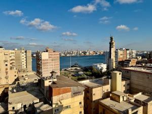 a view of a city with buildings and the water at Retaj Waterfront Penthouse in Port Said