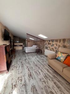 a large living room with a couch and a television at La Casa Los Patios in Mahora