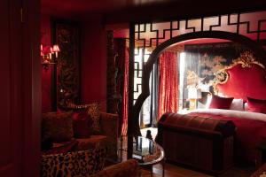a red bedroom with a bed and a glass table at Petit Ermitage in Los Angeles +64 photos
