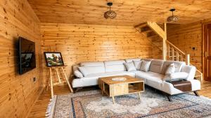 a living room with a couch and a table at Grahovo Mountain Chalet in Grahovo