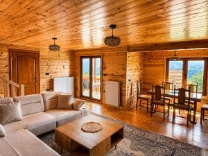 a living room with a couch and a table at Grahovo Mountain Chalet in Grahovo