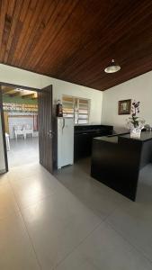 a kitchen with a white refrigerator in a room at Canto dos pássaros in Tramandaí