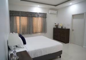 a white bedroom with a bed and a window at Onyx Villa in Ocho Rios +32 photos