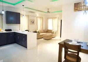 a kitchen and living room with a couch and a table at Onyx Villa in Ocho Rios