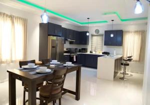 a kitchen with a table and chairs in a room at Onyx Villa in Ocho Rios