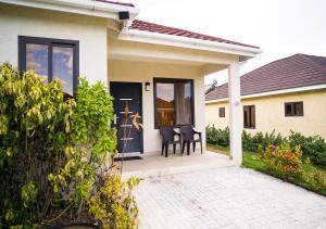 a house with a porch with a table and chairs at Onyx Villa in Ocho Rios