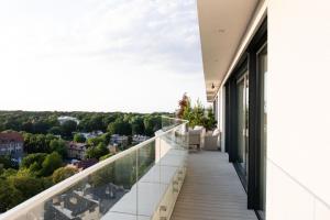 a balcony with a view of the city at Amber Sun Towers 11th Floor in Świnoujście