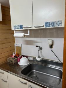 a kitchen counter with a sink and a mixer at 民宿とまとハウスTomato House in Funehiki +77 photos