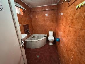 a bathroom with a tub and a toilet and a sink at Palma Hostel in Batumi +24 photos