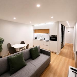 a living room with a couch and a table at Alameda Apartments 2 in Trofa