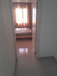 a bedroom with a window and a bed in a doorway at הבית של רוית in Qasrîne