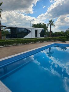an rv is parked next to a swimming pool at Vila Summer Depo in Sarandë