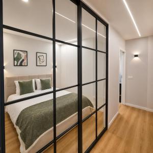 a bedroom with a large glass wall at Alameda Apartments 2 in Trofa