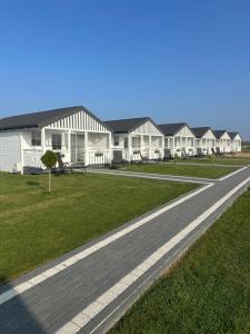 a road in front of a row of houses at Baltic Holidays in Gąski