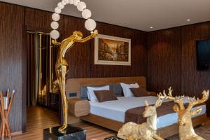 a bedroom with a bed with a gold bed frame at HH Point Luxury Villas in Durrës