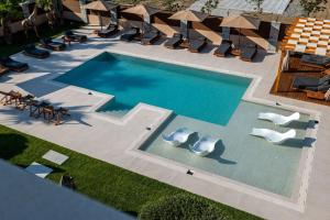 an overhead view of a swimming pool with lounge chairs at HH Point Luxury Villas in Durrës +131 photos