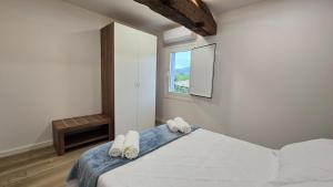 a bedroom with a bed with two slippers on it at Mirada Sacra in Parada del Sil