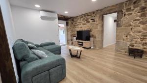 a living room with a couch and a tv at Mirada Sacra in Parada del Sil